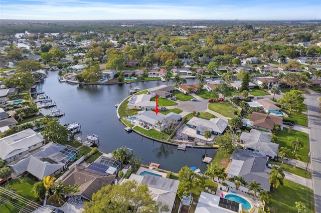 drone / aerial view with a water view and a residential view