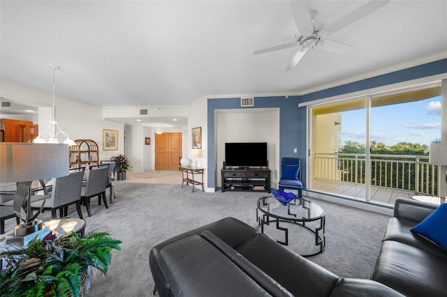 living room featuring carpet flooring, ceiling fan, and ornamental molding