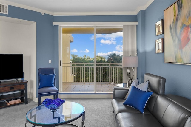 living room featuring carpet, a healthy amount of sunlight, and crown molding