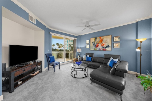 carpeted living room with crown molding and ceiling fan