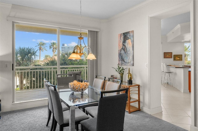 dining space with ornamental molding and light tile patterned flooring