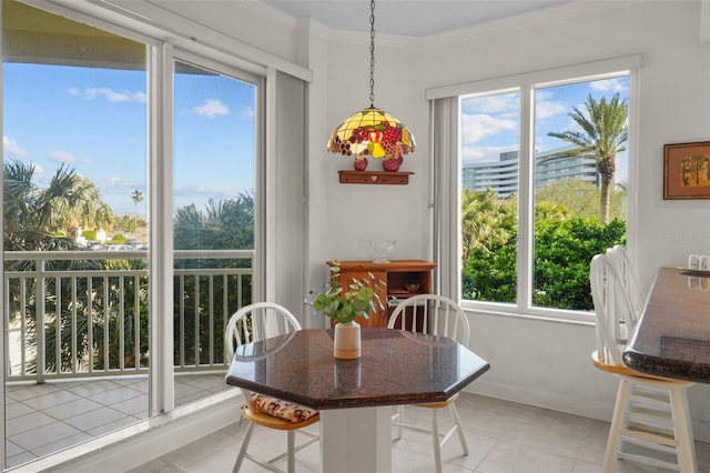 dining area featuring light tile patterned floors and ornamental molding