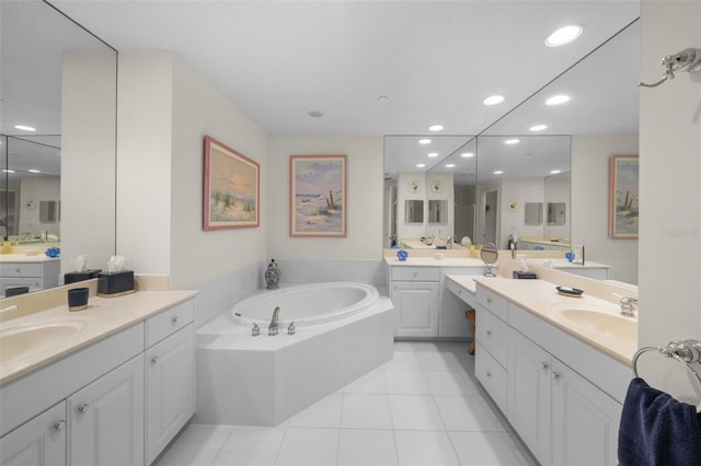 bathroom featuring tile patterned flooring, vanity, and tiled tub