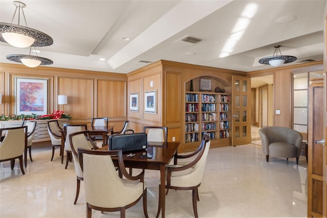 dining room with a raised ceiling