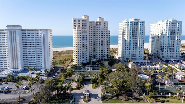 view of city featuring a beach view and a water view