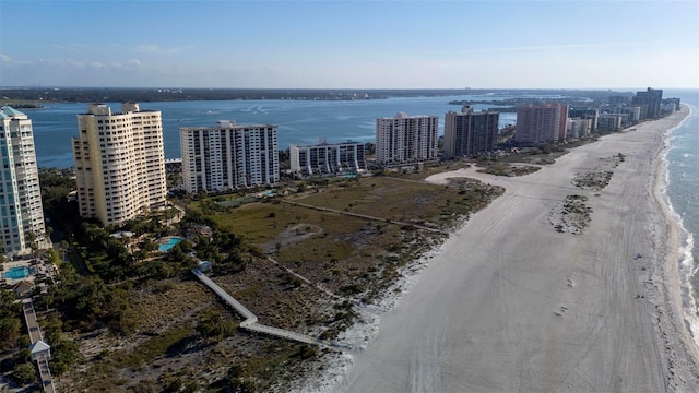 bird's eye view featuring a water view and a beach view