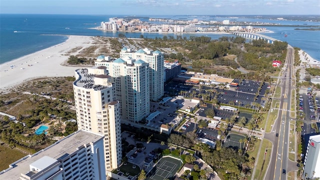 drone / aerial view featuring a water view and a beach view