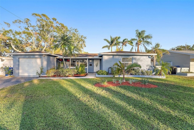 ranch-style home with a front lawn and a garage