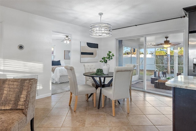 dining area with ceiling fan with notable chandelier and light tile patterned floors