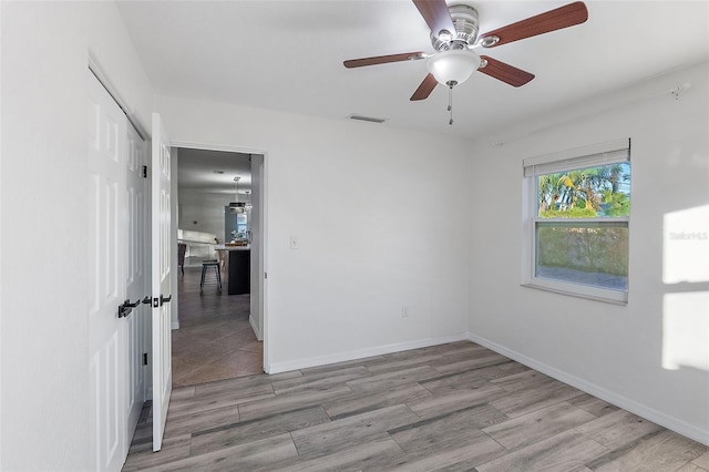 unfurnished room featuring ceiling fan and light hardwood / wood-style floors