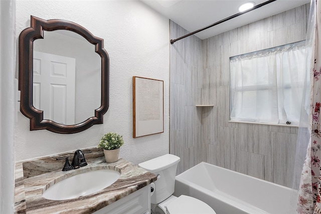 full bathroom with vanity, shower / bath combination with curtain, and toilet