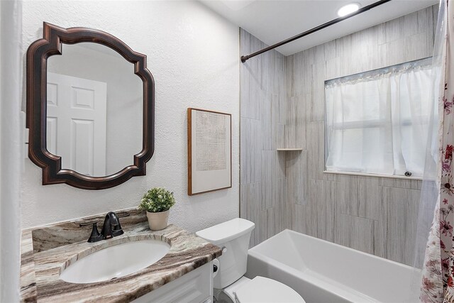 2461 61st Ln N, Saint Petersburg, FL 33710 - full bathroom featuring vanity, shower / bath combo with shower curtain, and a textured wall