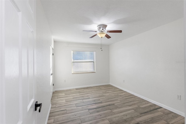 unfurnished room with ceiling fan and light hardwood / wood-style floors