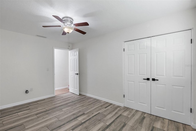 2461 61st Ln N, Saint Petersburg, FL 33710 - unfurnished bedroom with wood finished floors, a closet, and ceiling fan
