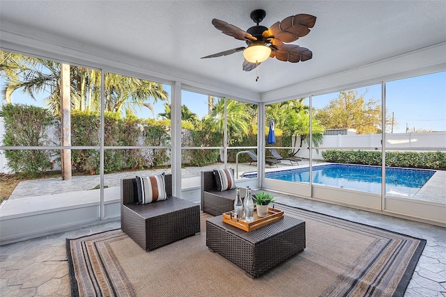 sunroom featuring ceiling fan