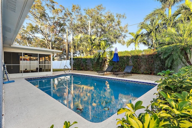 2461 61st Ln N, Saint Petersburg, FL 33710 - view of pool with a sunroom, a fenced backyard, and a patio