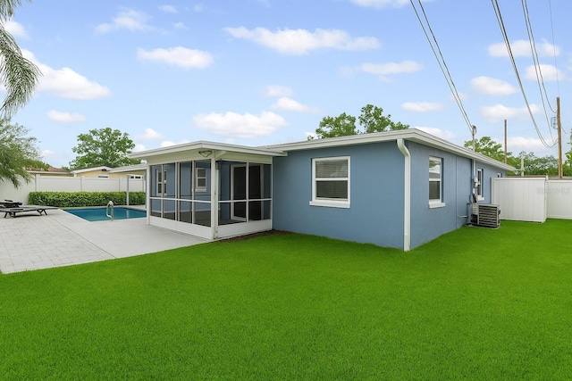 2461 61st Ln N, Saint Petersburg, FL 33710 - rear view of property featuring a sunroom, a fenced backyard, stucco siding, and a patio