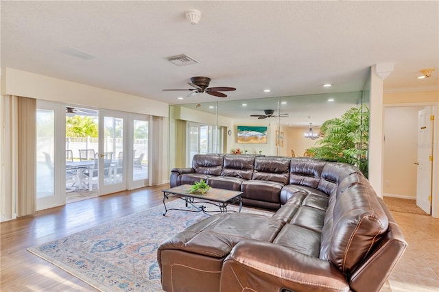 living room featuring ceiling fan and ornamental molding