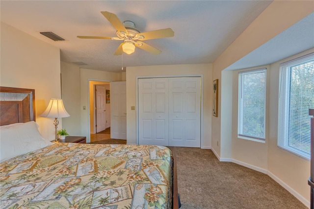 bedroom featuring ceiling fan, a closet, and carpet