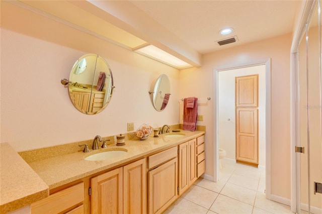 bathroom featuring tile patterned flooring, vanity, and toilet