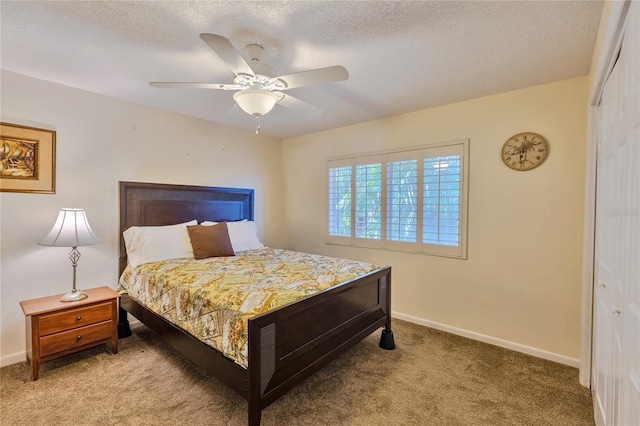 carpeted bedroom featuring a textured ceiling, a closet, and ceiling fan