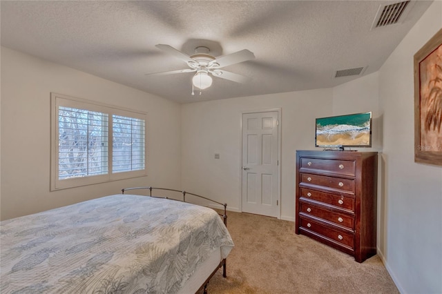 bedroom with light carpet, a textured ceiling, and ceiling fan