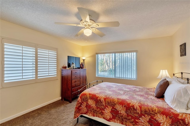 carpeted bedroom with a textured ceiling and ceiling fan