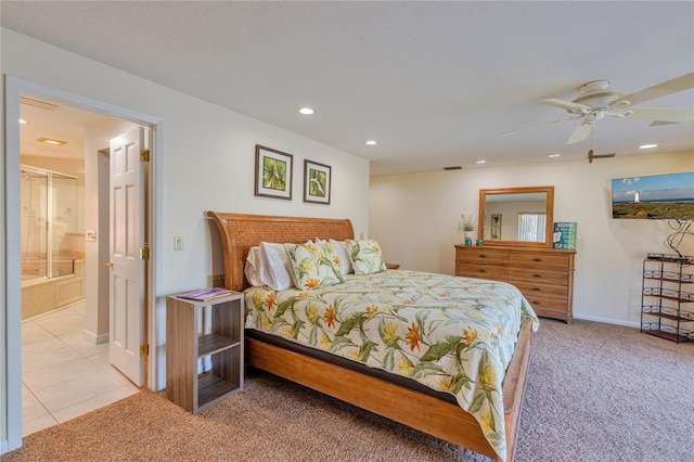 bedroom with connected bathroom, ceiling fan, and light carpet