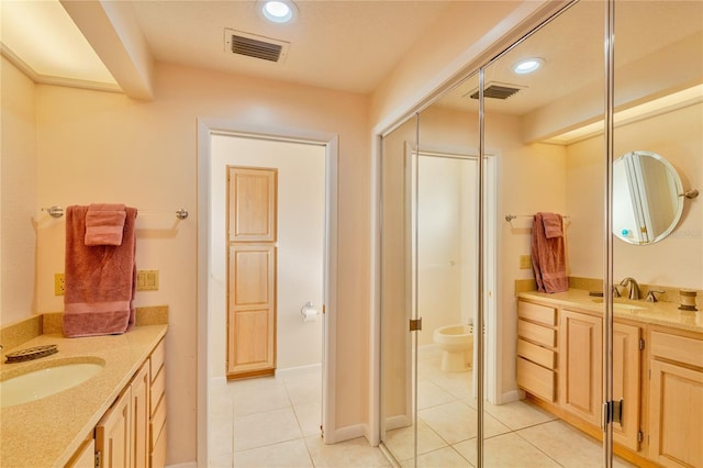 bathroom featuring tile patterned flooring and vanity