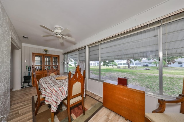 sunroom / solarium with a wealth of natural light and ceiling fan