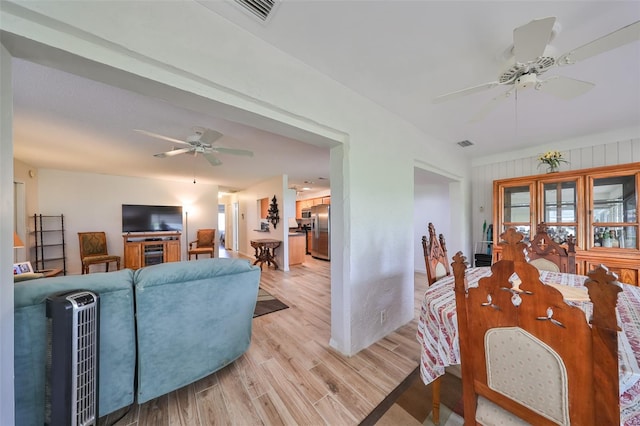 living room with wood walls and light hardwood / wood-style flooring