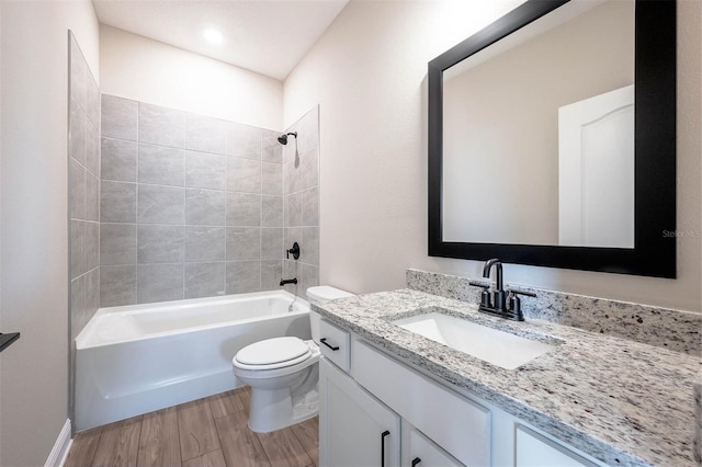 full bathroom with wood-type flooring, vanity, toilet, and tiled shower / bath