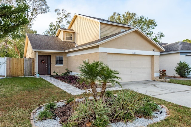 view of front facade with a garage and a front lawn