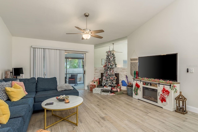 living room with light hardwood / wood-style flooring and ceiling fan