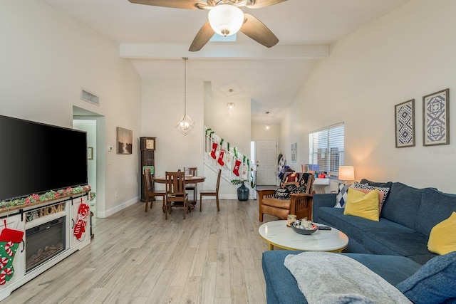 living room with beamed ceiling, ceiling fan, high vaulted ceiling, and light hardwood / wood-style flooring