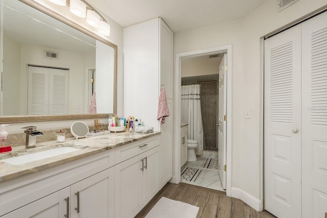 bathroom featuring hardwood / wood-style flooring, vanity, toilet, and a shower with curtain