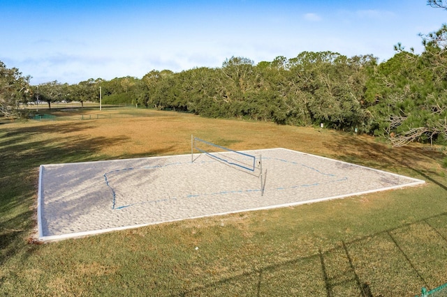 view of home's community featuring volleyball court and a yard