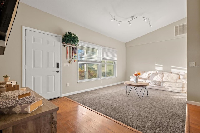 living room with hardwood / wood-style floors and vaulted ceiling