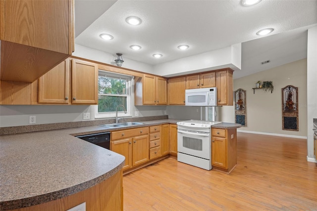 kitchen with white appliances, sink, light wood-type flooring, a textured ceiling, and kitchen peninsula