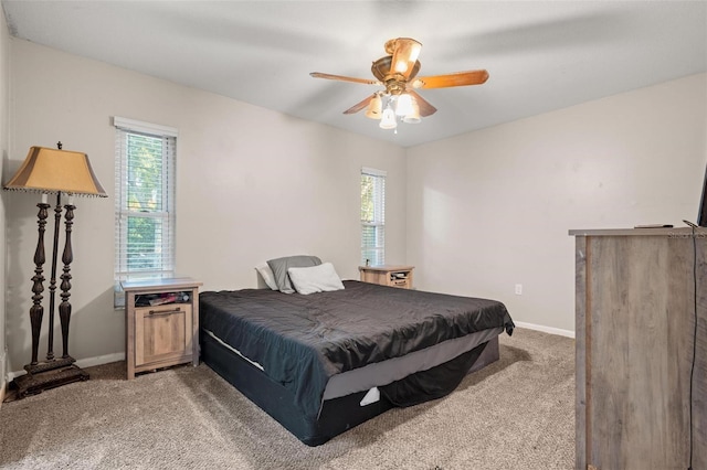 carpeted bedroom featuring ceiling fan, pool table, and multiple windows