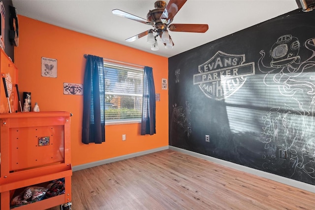 bedroom with ceiling fan and hardwood / wood-style flooring