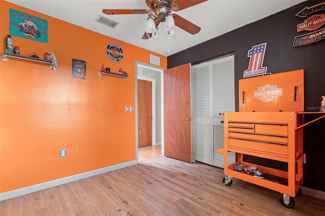 bedroom featuring wood-type flooring, a closet, and ceiling fan