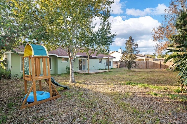 view of yard with a playground and a patio