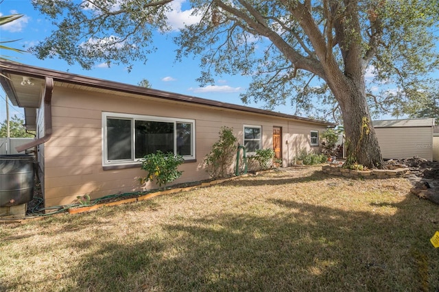 exterior space with a lawn and a storage shed