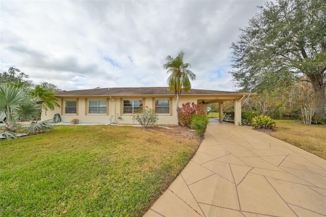 2003 Halmrock Pl, Sun City Center, FL 33573 - view of front of house featuring concrete driveway, a front yard, stucco siding, and an attached carport