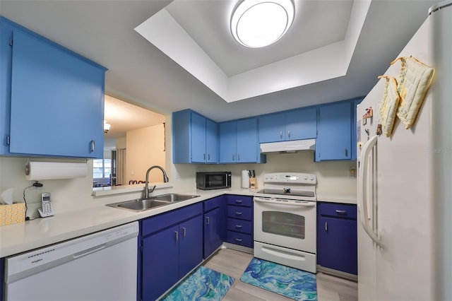 kitchen with blue cabinetry, white appliances, and sink