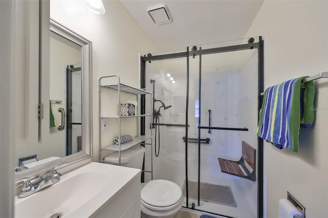 bathroom featuring vanity, toilet, and walk in shower