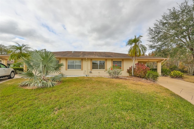 2003 Halmrock Pl, Sun City Center, FL 33573 - view of front facade featuring concrete driveway, a front lawn, and stucco siding