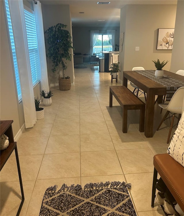 hall featuring light tile patterned floors