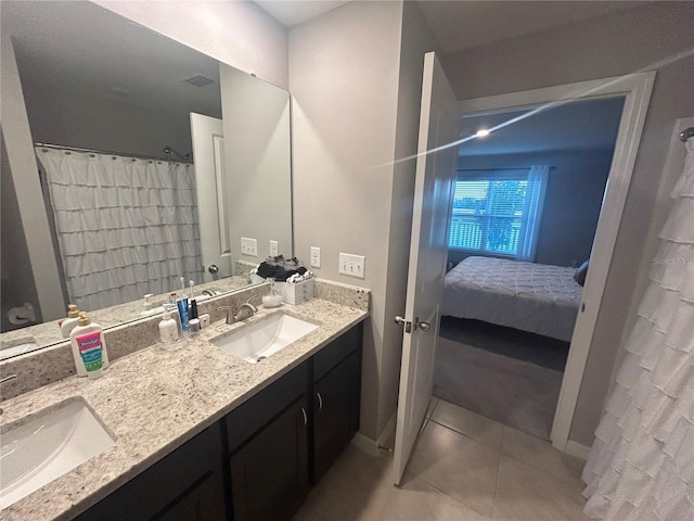 bathroom with tile patterned floors and vanity